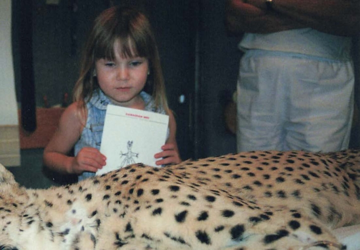A young Mikaela offering a get-well card to a cheetah undergoing an MRI.